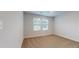 Bedroom with a large window, neutral walls, and plush carpet flooring at 637 Egrets Landing #51, Covington, GA 30014