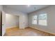 Bright bedroom featuring hardwood floors, neutral paint, and two windows at 637 Egrets Landing #51, Covington, GA 30014