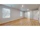 Spacious primary bedroom featuring hardwood flooring, natural light, and a sliding barn door at 637 Egrets Landing #51, Covington, GA 30014