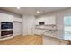 Modern kitchen with stainless double oven, granite counters, white cabinets, and hardwood floors at 637 Egrets Landing #51, Covington, GA 30014
