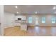 Bright, open kitchen featuring white cabinets, stainless appliances, granite counters and hardwood flooring at 637 Egrets Landing #51, Covington, GA 30014