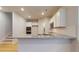 Modern open kitchen with stainless appliances, white cabinets, granite counters, and hardwood floors at 637 Egrets Landing #51, Covington, GA 30014