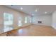 Open concept living room and kitchen area with hardwood floors and plenty of natural light at 637 Egrets Landing #51, Covington, GA 30014