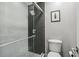 Modern bathroom showcasing a tiled shower with glass door and contemporary fixtures at 17 Willow Ne Gln, Atlanta, GA 30342