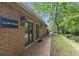 Exterior of clubhouse featuring brick facade, walkway, and inviting entry doors at 17 Willow Ne Gln, Atlanta, GA 30342