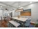 Dining room with a wooden table and gray chairs, with a modern light fixture overhead at 17 Willow Ne Gln, Atlanta, GA 30342