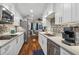 Galley kitchen with white cabinets, stainless steel appliances, a sink, and wooden floors at 17 Willow Ne Gln, Atlanta, GA 30342