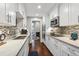 Galley kitchen with white cabinets, stainless steel appliances, and tile backsplash at 17 Willow Ne Gln, Atlanta, GA 30342