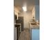 Well lit kitchen featuring granite counters, stainless steel appliances, and tile flooring at 23210 Plantation Ne Dr, Atlanta, GA 30324