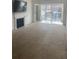 Bright living room with sliding glass doors, fireplace and neutral carpeting at 23210 Plantation Ne Dr, Atlanta, GA 30324