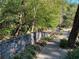 Scenic community walking path along a stone wall, ideal for peaceful strolls and nature appreciation at 23210 Plantation Ne Dr, Atlanta, GA 30324
