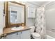 Cozy bathroom features neutral color palette, vanity, large mirror and shower-tub combo at 5153 Roswell Rd # 10, Atlanta, GA 30342