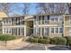 Traditional two-story condo building with muted siding, black shutters and lush landscaping at 5153 Roswell Rd # 10, Atlanta, GA 30342
