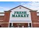 Facade of The Fresh Market store featuring a red brick design, large signage, and welcoming entrance at 5153 Roswell Rd # 10, Atlanta, GA 30342