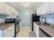 Efficient kitchen with stainless appliances, white cabinetry, and neutral countertops at 5153 Roswell Rd # 10, Atlanta, GA 30342