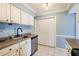 Well-appointed kitchen offers white cabinets, stainless appliances, and tiled flooring at 5153 Roswell Rd # 10, Atlanta, GA 30342