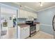 Efficient kitchen with stainless appliances, white cabinetry, and a view into living spaces at 5153 Roswell Rd # 10, Atlanta, GA 30342