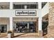 Apricot Lane boutique storefront with large display windows and brick accents and outdoor walkway at 5153 Roswell Rd # 10, Atlanta, GA 30342