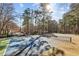 An outdoor tennis court sits near the parking lot and surrounded by mature trees at 5153 Roswell Rd # 10, Atlanta, GA 30342