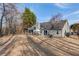 Wide view of sprawling fenced in yard with a home featuring a covered patio at 5883 Riverside Walk Dr, Sugar Hill, GA 30518