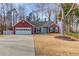 Charming single Gathering home features brick accents, attached two car garage, mature trees and landscaping at 5883 Riverside Walk Dr, Sugar Hill, GA 30518