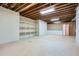 Unfinished basement with exposed beams, concrete floor, shelving, and room for storage at 1725 Patriots Nw Way, Kennesaw, GA 30152