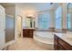 Luxurious bathroom showcasing a garden tub, separate shower, and dual vanities at 1725 Patriots Nw Way, Kennesaw, GA 30152