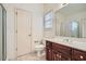 Bathroom featuring a wood vanity with a sink, tile floor, toilet, and a glass-enclosed shower at 1725 Patriots Nw Way, Kennesaw, GA 30152