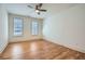 Bedroom with hardwood floors, two windows with blinds, and a ceiling fan at 1725 Patriots Nw Way, Kennesaw, GA 30152