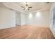 Large bedroom featuring hardwood floors, tray ceiling, and natural light from the window at 1725 Patriots Nw Way, Kennesaw, GA 30152