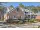 A view of the side of this beautiful brick home with mature landscaping at 1725 Patriots Nw Way, Kennesaw, GA 30152