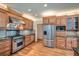 Well-equipped kitchen with stainless steel range hood, granite counters, and wood cabinets at 1725 Patriots Nw Way, Kennesaw, GA 30152