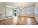 Spacious living room featuring hardwood floors, large windows, and elegant chandelier lighting at 1725 Patriots Nw Way, Kennesaw, GA 30152