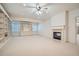 Spacious living room featuring built-in shelving, a fireplace, and neutral carpet at 1725 Patriots Nw Way, Kennesaw, GA 30152