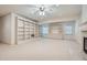 Large living room featuring built-in shelving, a fireplace, and neutral carpet at 1725 Patriots Nw Way, Kennesaw, GA 30152