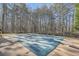 A covered pool with a safety cover surrounded by a wooded landscape at 1725 Patriots Nw Way, Kennesaw, GA 30152