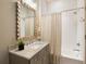 Bathroom with modern vanity, patterned shower curtain, and a decorative mirror above the sink at 2629 Ashford Ne Rd, Brookhaven, GA 30319