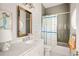 Bathroom featuring gray brick, colorful shower curtain, and a modern white marble vanity with gold hardware at 2629 Ashford Ne Rd, Brookhaven, GA 30319