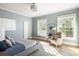 Bedroom with natural light, hardwood floors, and a comfortable reading chair in a sun-drenched space at 2629 Ashford Ne Rd, Brookhaven, GA 30319