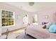 Pink bedroom featuring natural light from windows, a plush rug, and a decorative unicorn picture at 2629 Ashford Ne Rd, Brookhaven, GA 30319