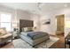 Comfortable bedroom with a tufted headboard, soft rug, and neutral tones at 2629 Ashford Ne Rd, Brookhaven, GA 30319