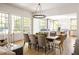 Bright dining room features hardwood floors, large windows, and a modern chandelier above the table at 2629 Ashford Ne Rd, Brookhaven, GA 30319