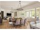 Dining room open to the living room features hardwood floors and a modern chandelier at 2629 Ashford Ne Rd, Brookhaven, GA 30319