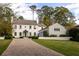 Elegant home with a brick driveway, manicured lawn, and a charming front entrance at 2629 Ashford Ne Rd, Brookhaven, GA 30319