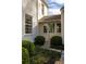 Close up of the side entryway featuring a light-colored door, multiple windows, and beautiful landscaping at 2629 Ashford Ne Rd, Brookhaven, GA 30319