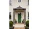 Stylish front door with an ornamental portico and manicured landscaping at 2629 Ashford Ne Rd, Brookhaven, GA 30319