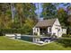 Inviting pool house features outdoor seating, a lounge area, and a sparkling pool at 2629 Ashford Ne Rd, Brookhaven, GA 30319