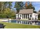 Charming pool house with patio area, lounge chairs and an inviting pool at 2629 Ashford Ne Rd, Brookhaven, GA 30319