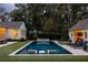 Inviting backyard pool with lounge chairs and manicured lawn, perfect for relaxing and entertaining outdoors at 2629 Ashford Ne Rd, Brookhaven, GA 30319