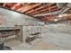 Unfinished basement area with exposed beams and cinder block walls, offering a blank canvas for future renovations at 2941 Pine Valley Cir, East Point, GA 30344